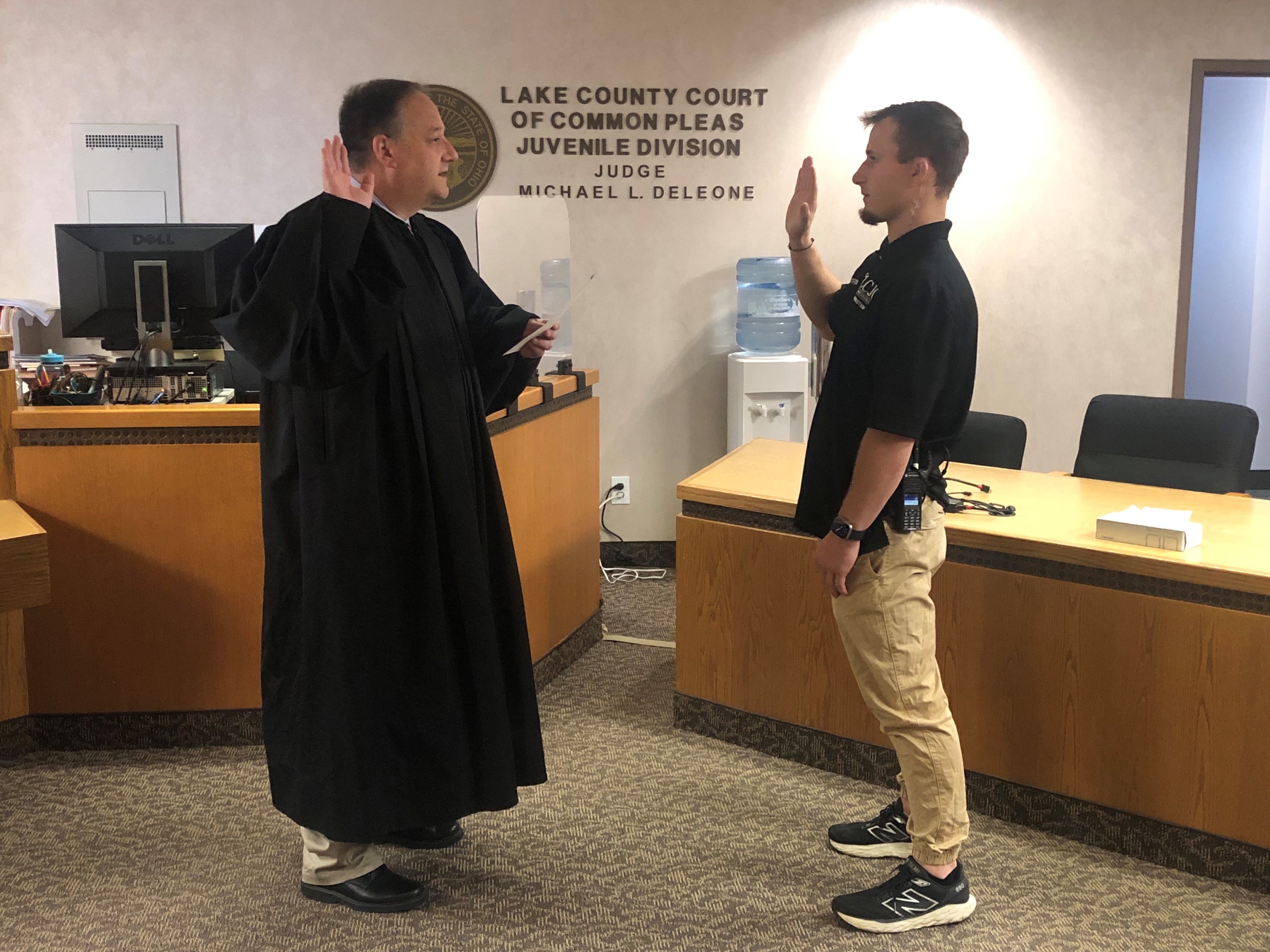 Judge DeLeone swearing in James Penfold as a Juvenile Corrections Officer.