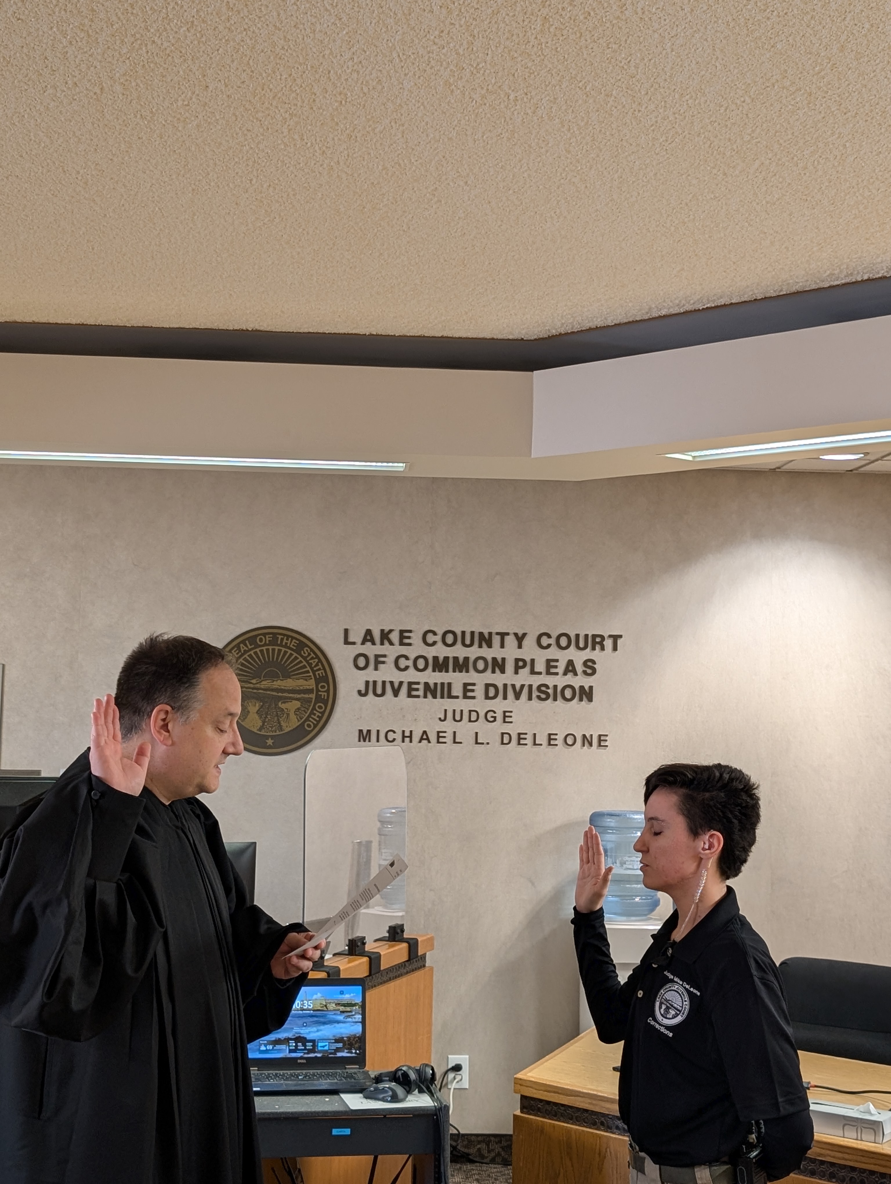 Judge DeLeone swearing in Logan Kyle as a Juvenile Corrections Officer.