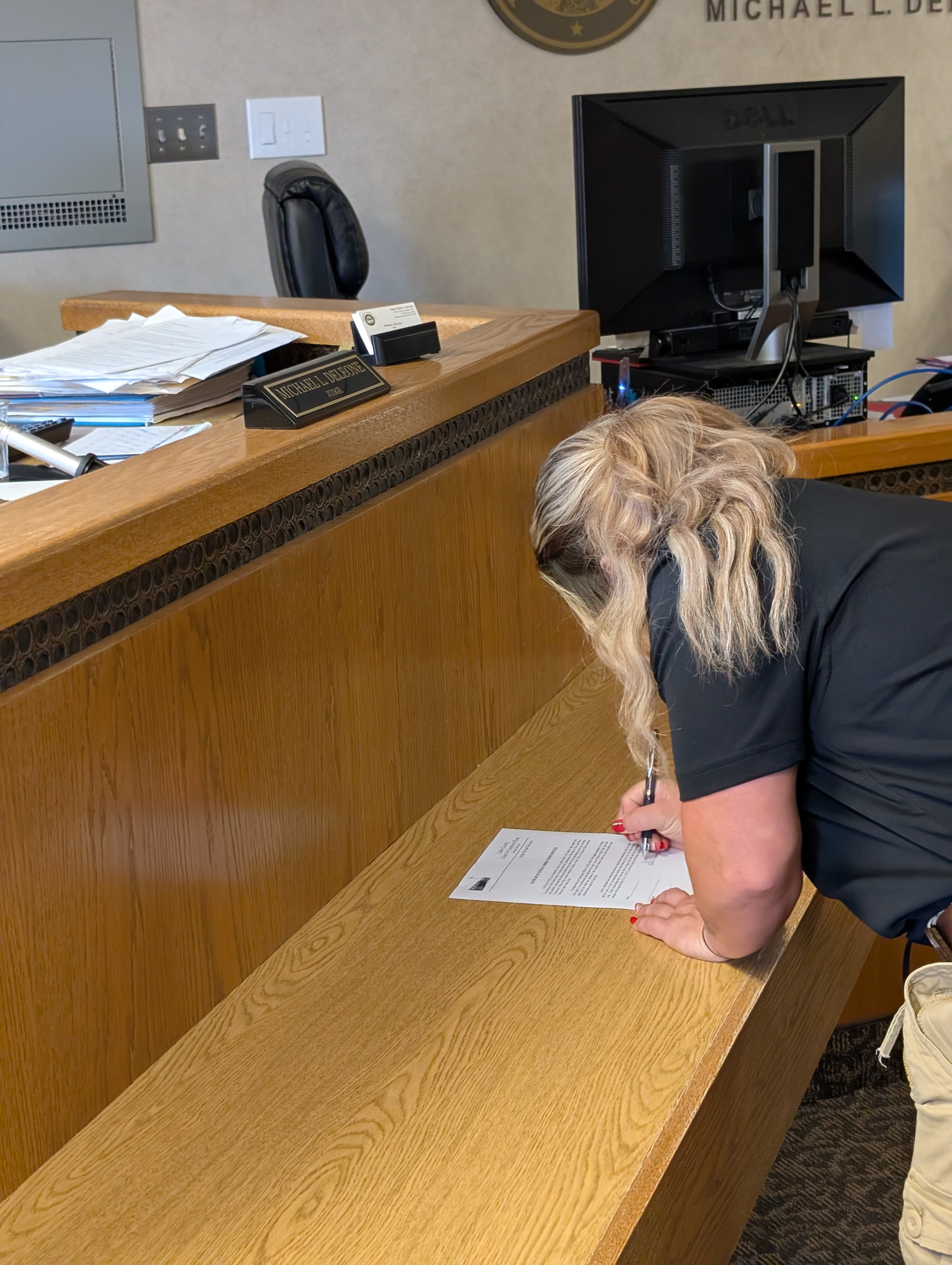 Judge DeLeone swearing in Natalie Pace as a Juvenile Corrections Officer.