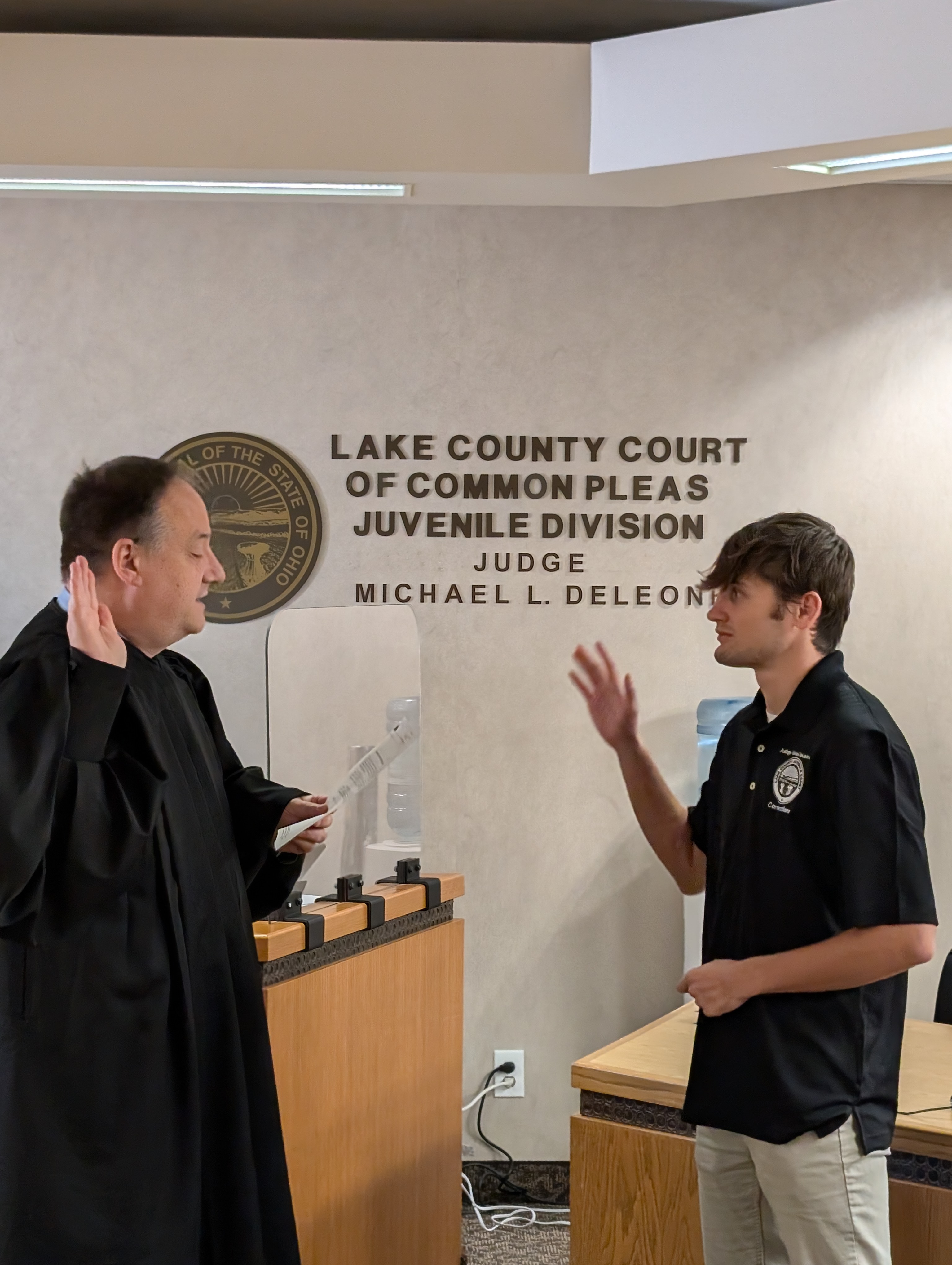 Judge DeLeone swearing in Brenden Hamilton as a Juvenile Corrections Officer.