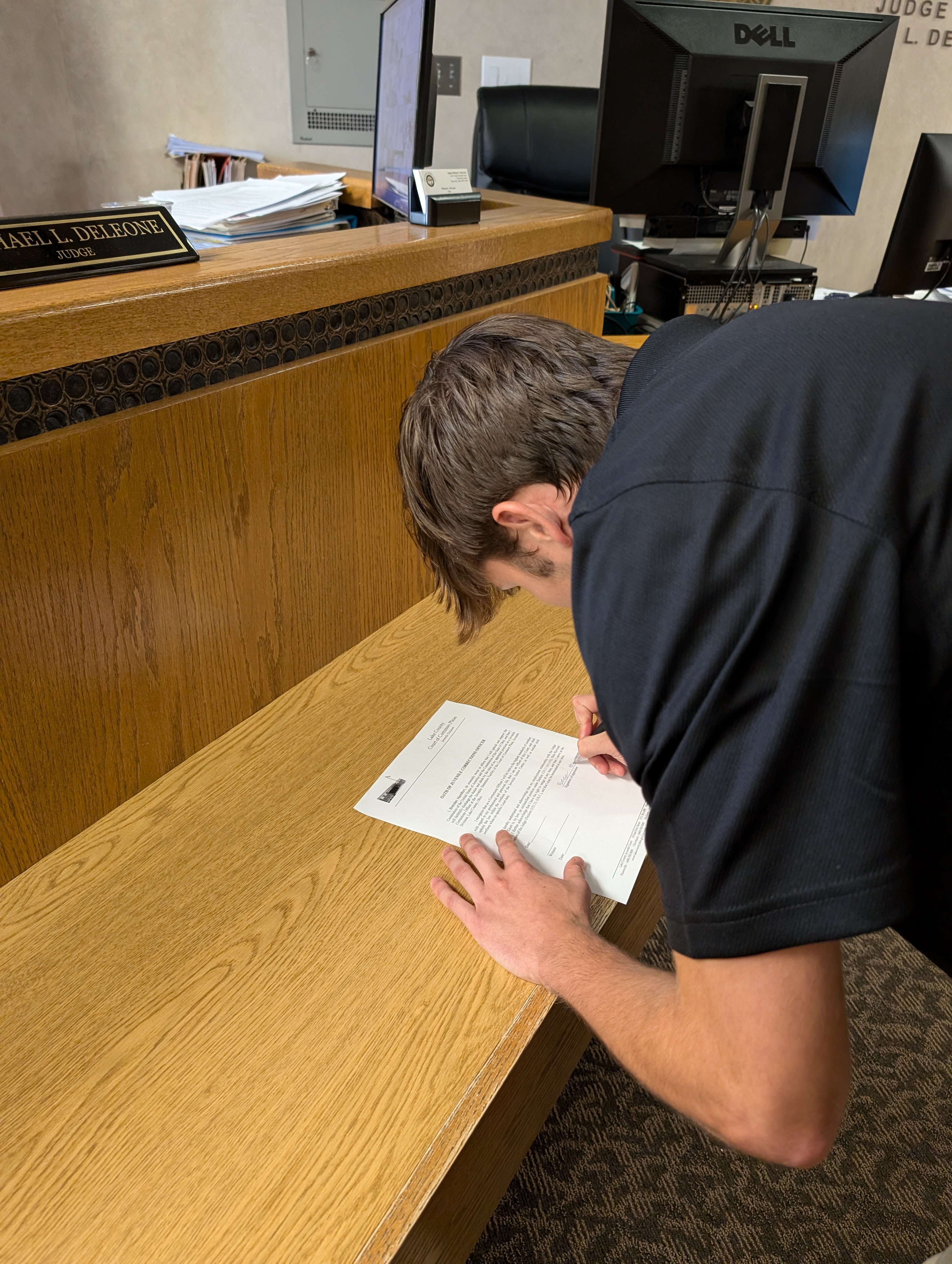 Judge DeLeone swearing in Brenden Hamilton as a Juvenile Corrections Officer.